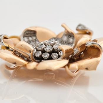 A 1940/50s brooch by Boucheron, in the shape of a flower, set with brilliant cut diamonds.