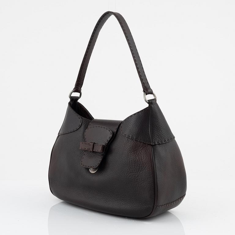 Prada, a brown leather bag.