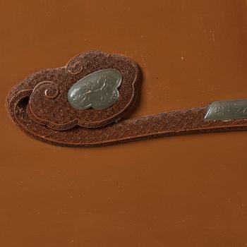 A lacquer wall panel with inlay of stone, cloisonné and porcelain, Qing dynasty, 19th Century.