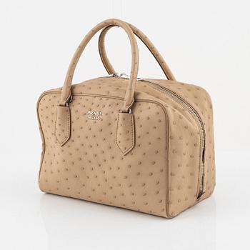Prada, a beige ostrich leather bag.