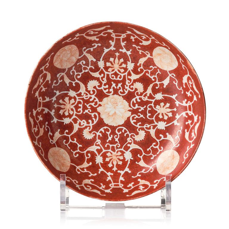 A coral-red reverse decorated dish, Qing dynasty with Guangxu mark and of the period (1875-1908).