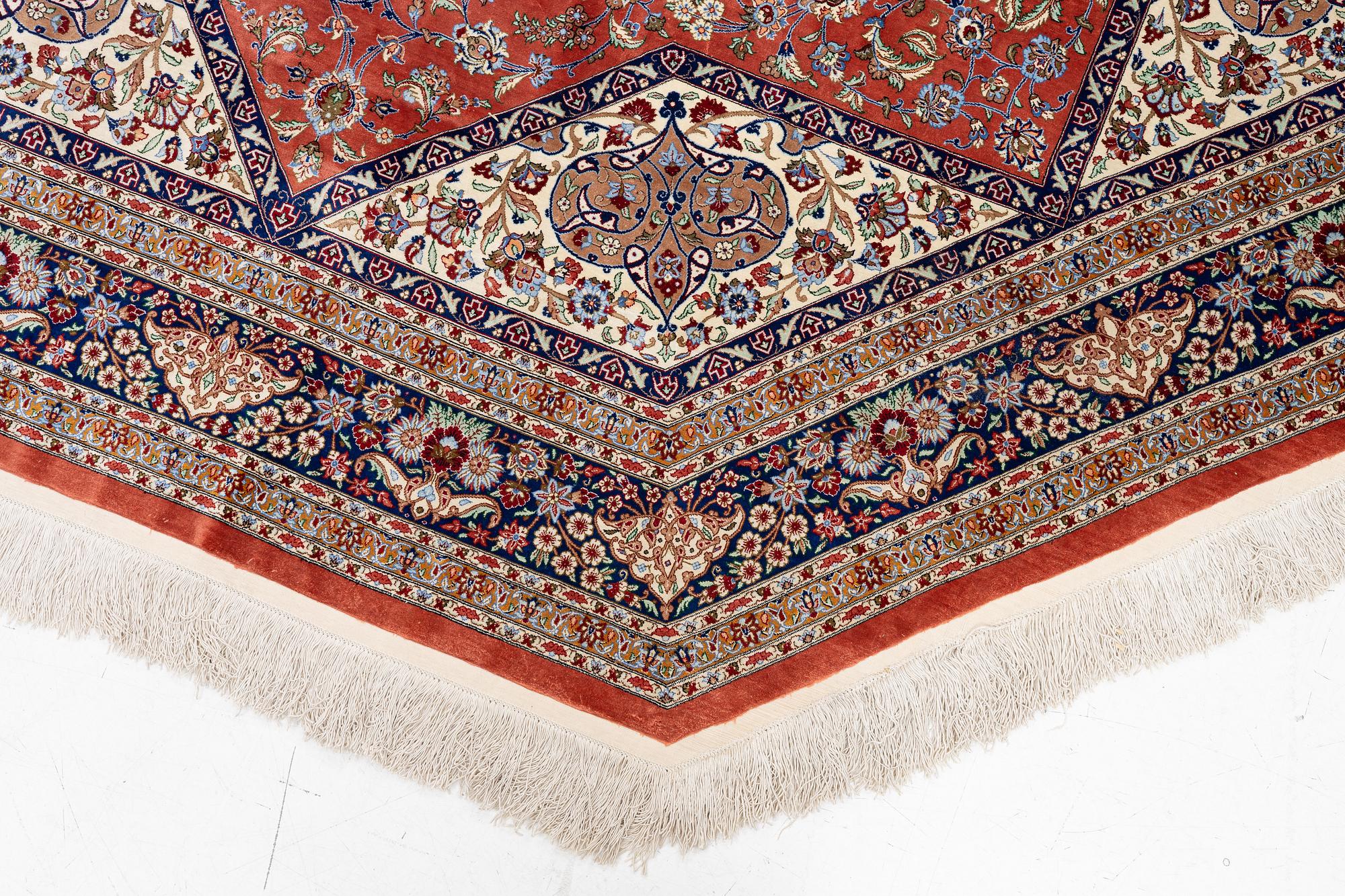 An Oktagonal  silk Qum rug, Central Persia, signed, c. 250 x 250 cm.