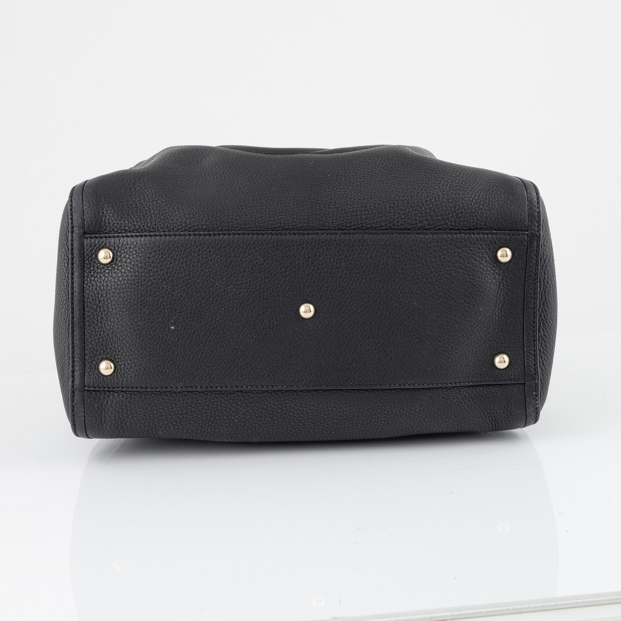 Gucci, a black leather handbag.