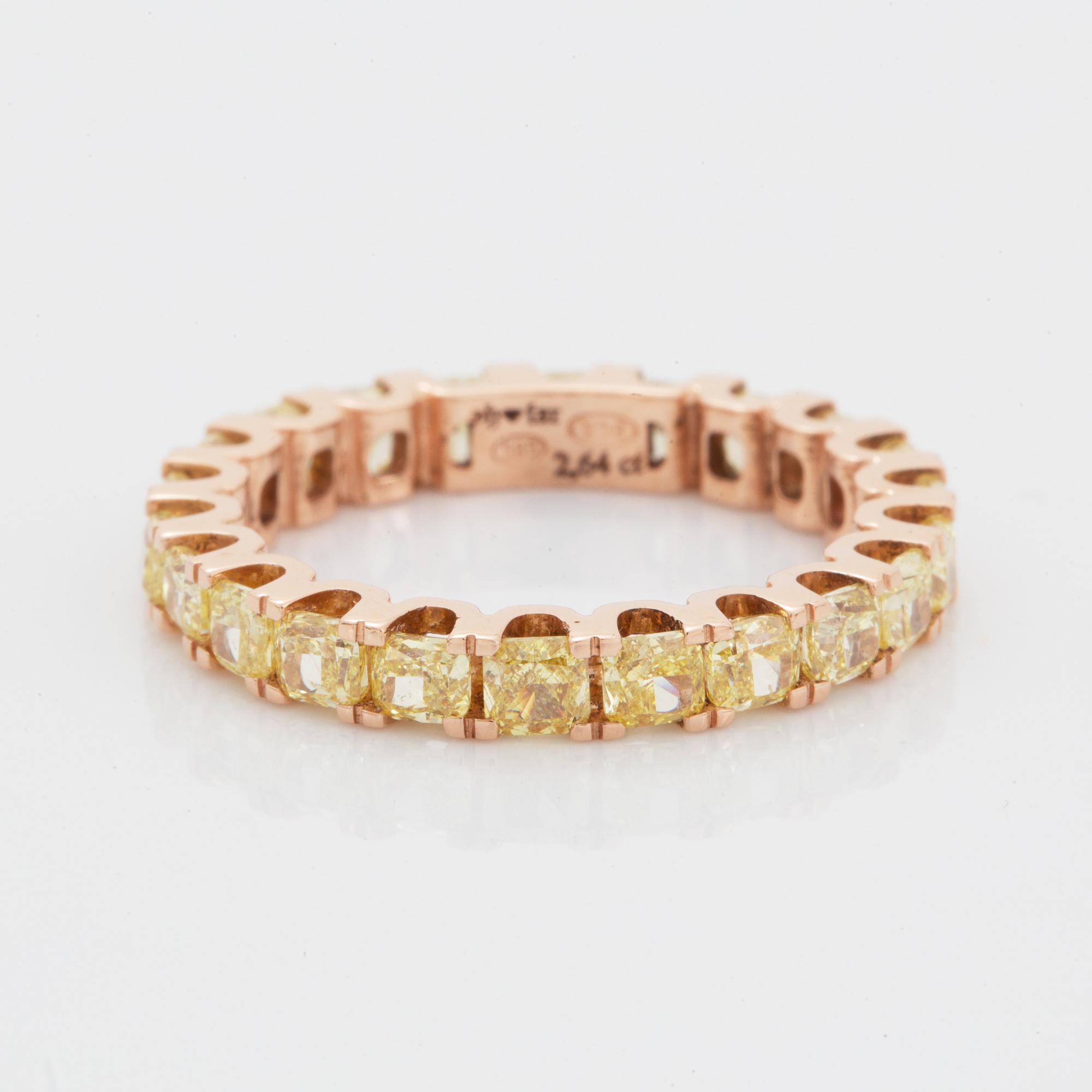 Cushion-cut yellow diamond eternity ring.