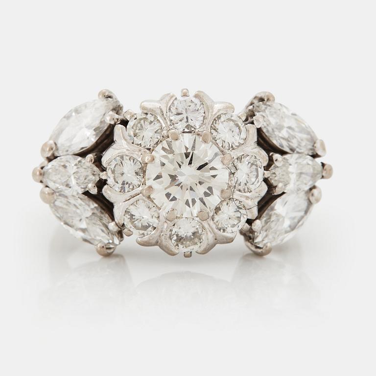 An 18K white gold ring set with round brilliant- and navette-cut diamonds.