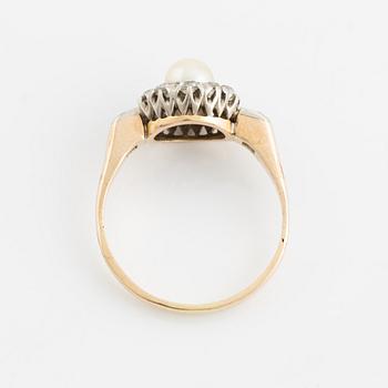 A 14K gold ring set with a pearl and old-cut diamonds.