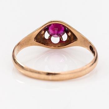 A 14K gold ring with a synthetic ruby.