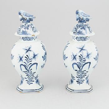 A pair of 19th century blue/white faience lidded jars, probably Dutch.