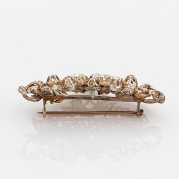 A silver brooch set with old-cut diamonds.