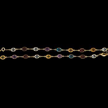 1099. NECKLACE, different faceted coloured gemstones.
