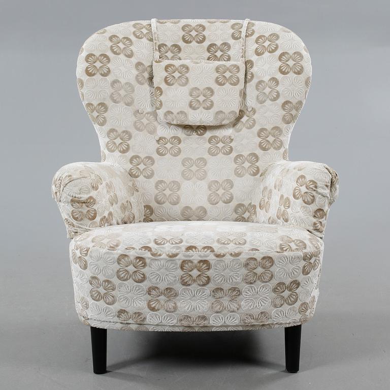 An armchair named "Rundrygg", designed by Carl Malmsten and made by OH Sjögren in 2011.