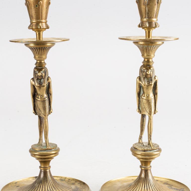 A pair of early 20th century brass candle sticks.