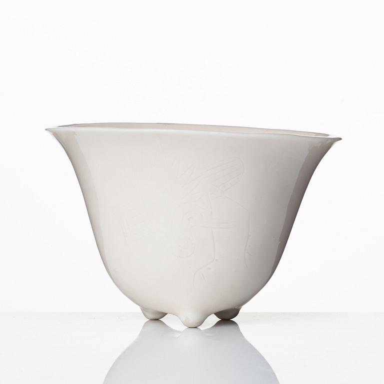 A rhinoserous shaped blanc de chine libation cup, Qing dynasty.