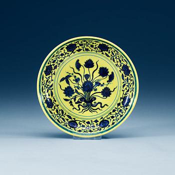 1697. A yellow glazed blue and white lotus dish, mark and period of Yongzheng (1723-35).