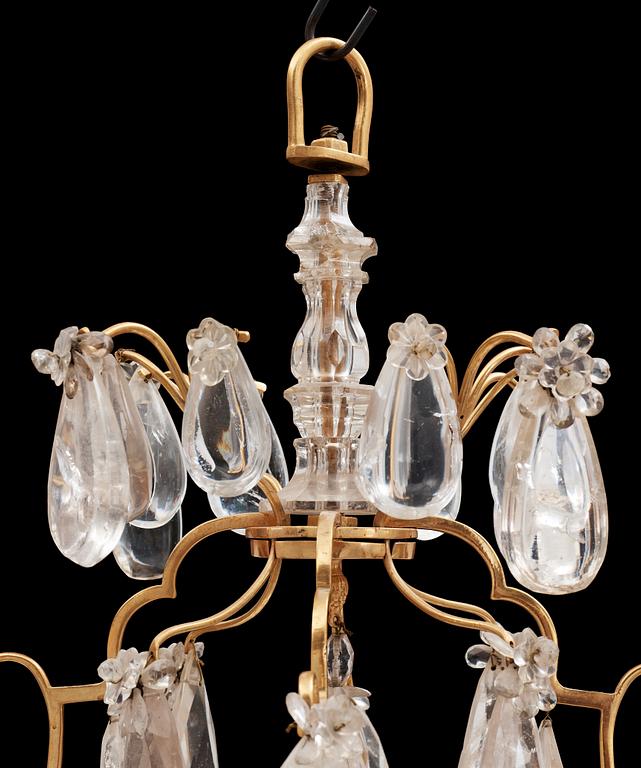 A late Baroque-style circa 1900 rock crystal twelve-light chandelier.