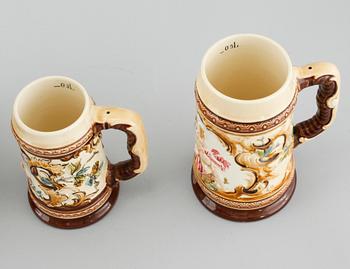 A jug and twelve beer mugs, majolica, around turn of the century 1900.