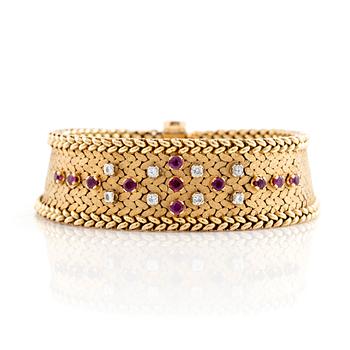 An 18K gold bracelet set with round brilliant-cut diamonds and rubies.
