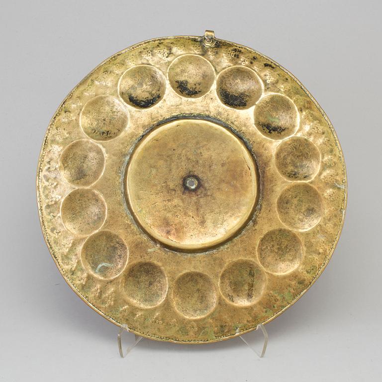 A probably 17th century brass wall plaque.