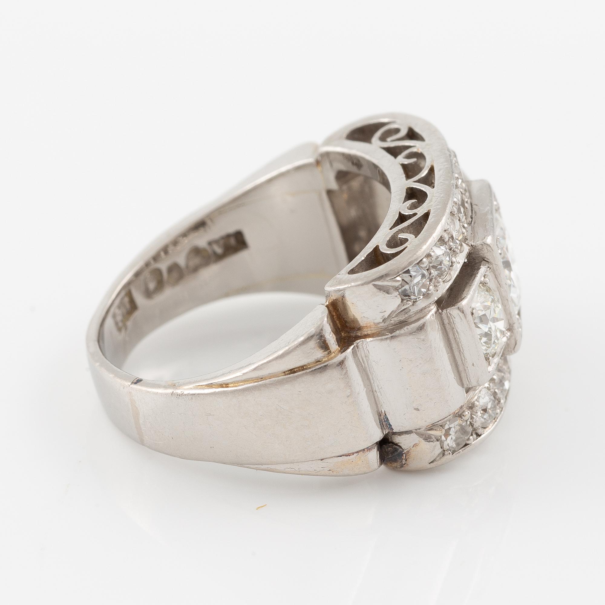 A platinum ring set with round brilliant and old-cut diamonds.