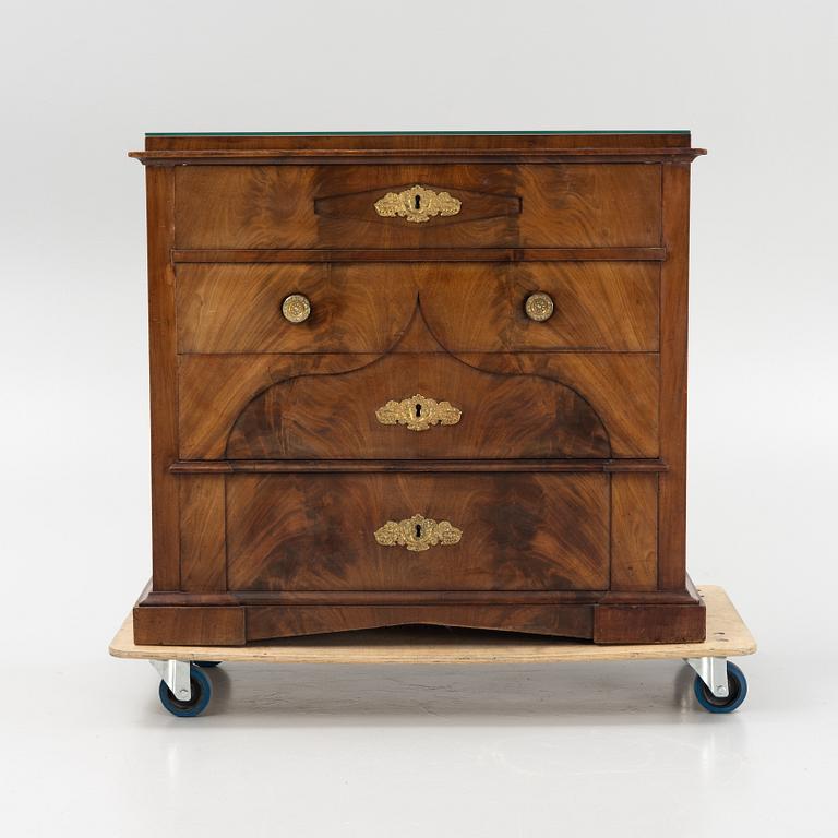 A mahogany veneered Empire chest of drawers, first half of the 20th Century.