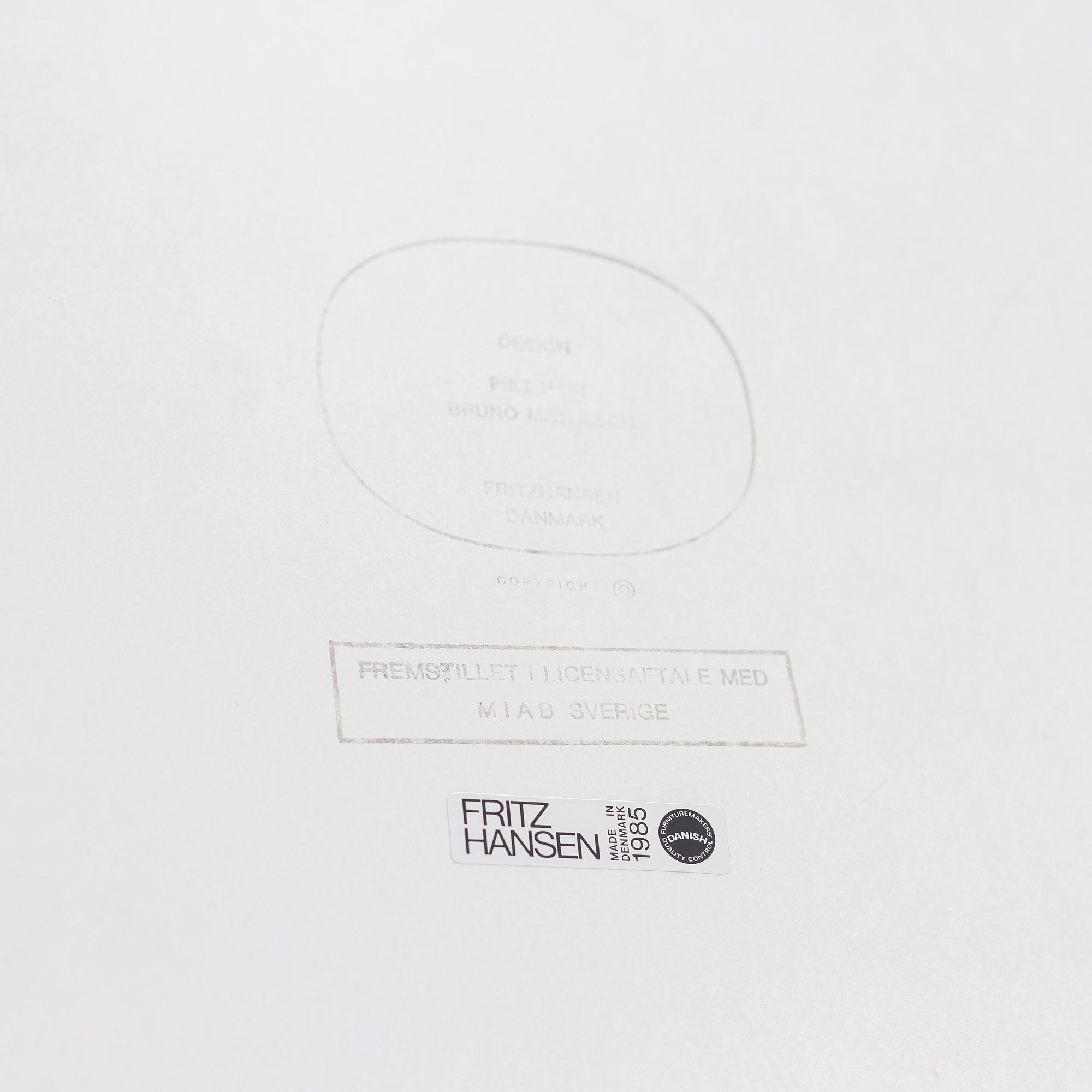 A 'Supercircular' table by Bruno Mathsson & Piet Hein for Fritz Hansen, dated 1985.