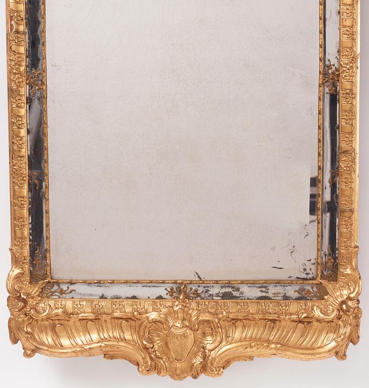 A Swedish rococo carved giltwood and gesso mirror, later part of the 18th century.