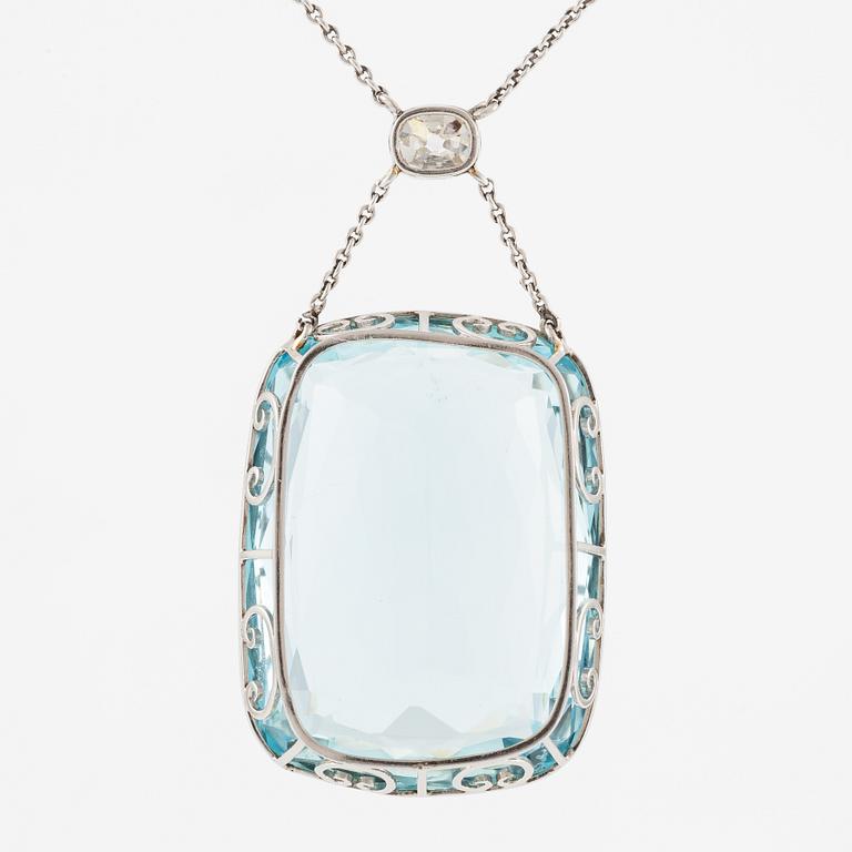 A platinum necklace with a faceted aquamarine and an oval old-cut diamond.