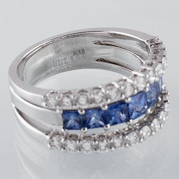 RING, 18K vitguld med 26 briljantslipade diamanter 0.88 ct samt 7 blå safirer 1.36 ct. Vikt 7,8 gram.