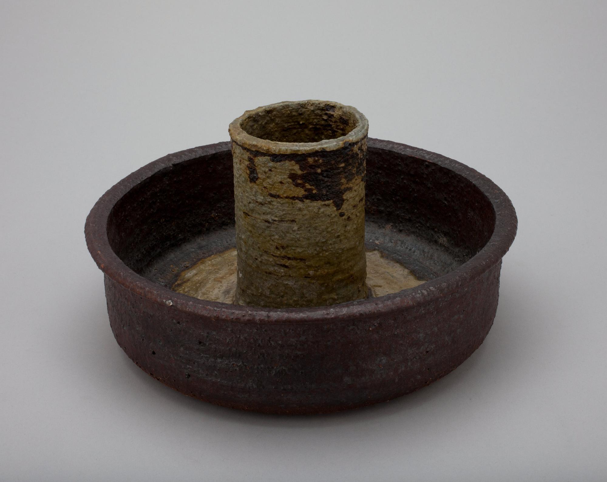 A CERAMIC CANDLESTICK.