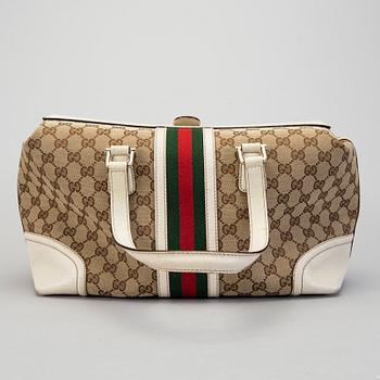 A Gucci canvas and leather hand bag.