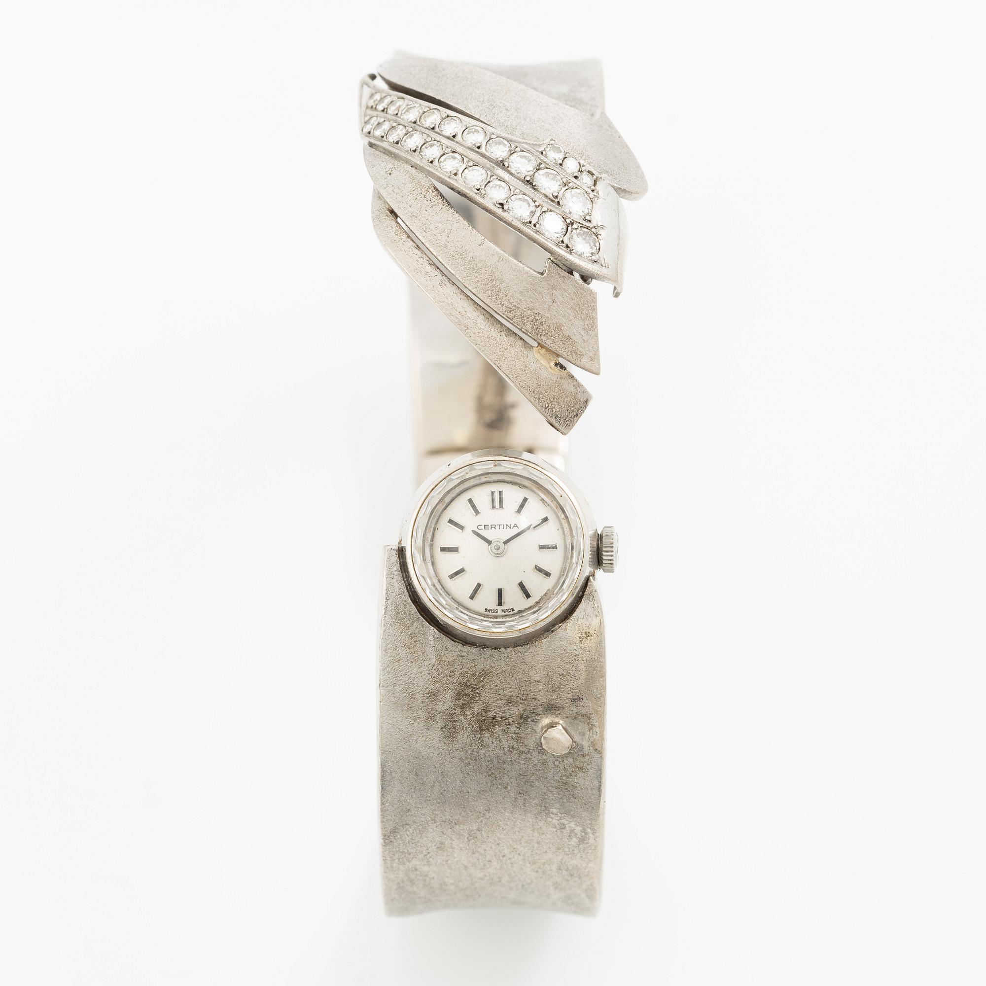 Aftonklocka/armring, Bo Dolk, 18K vitguld med briljantslipade diamanter, 1970-tal.