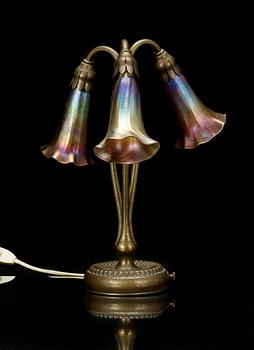 A Tiffany Studios 'Three Lily' lamp with a bronze base, New York circa 1910.