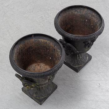 A pair of cast iron garden urns, Norrtälje dated 1989.