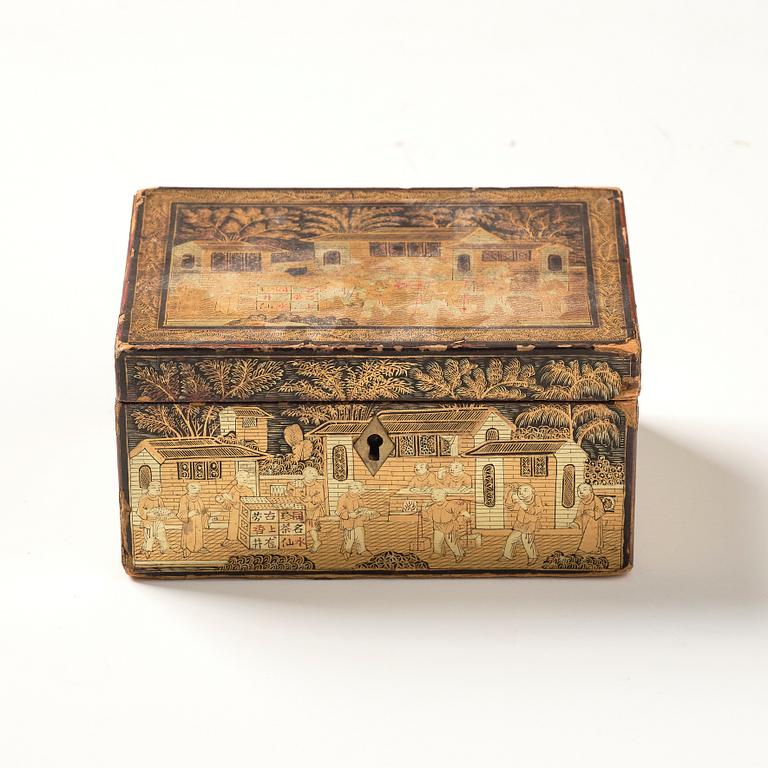 A lacquer tea box and a blanc de chine cup, Qing dynasty 18/19th century.