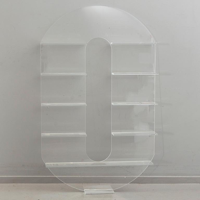 Shelf, plexi glass, in the shape of the letter 'O',Non Violence.