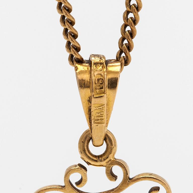 An 18K gold locket pendant, with chain in 14K gold.