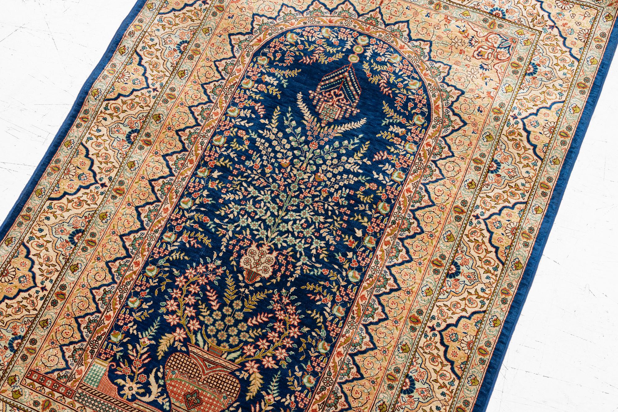A semi-antique silk Hereke rug, West Anatolia, signed c. 107 x 72 cm.