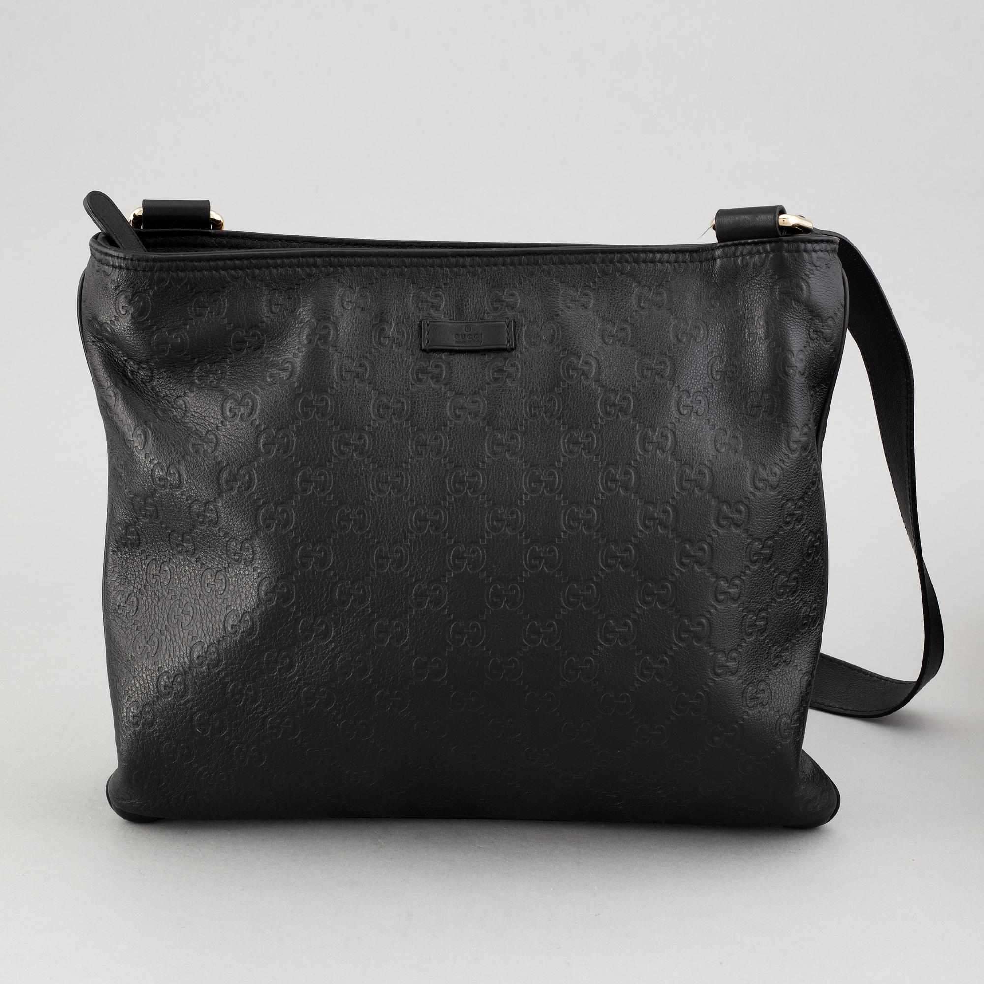 Gucci, a leather messenger bag.
