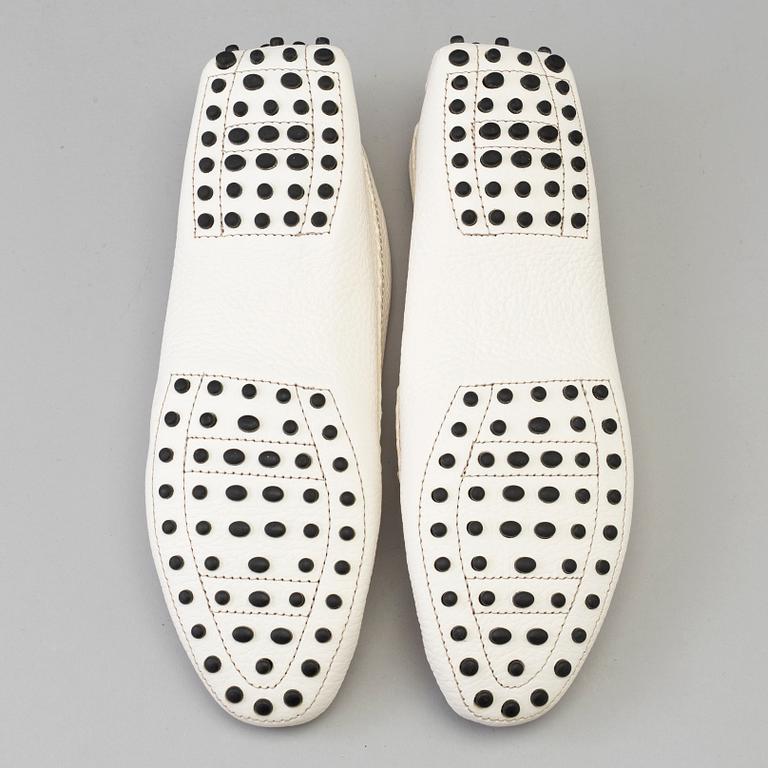 A pair of white leather loafers by Tod's.