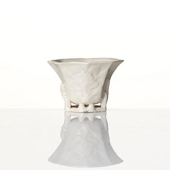 A lacquer tea box and a blanc de chine cup, Qing dynasty 18/19th century.