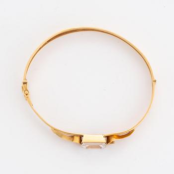 18K gold bangle and white synthetic stones.