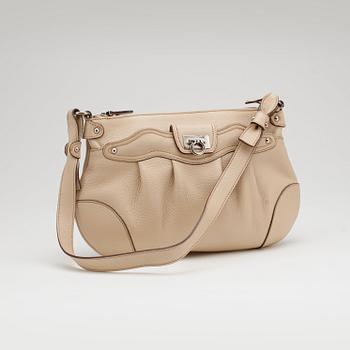 SALVATORE FERRAGAMO, a beige leather shoulder bag and a pair of beige leather loafers.