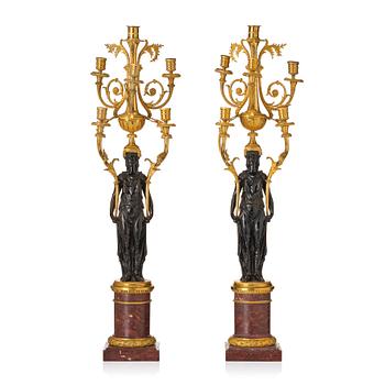 144. A pair of Louis XVI ormolu and patinated bronze six-branch candelabra attributed to François Rémond, late 18th century.