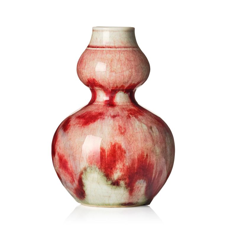 A Chinese peach bloom double gourd vase, Qing dynasty.