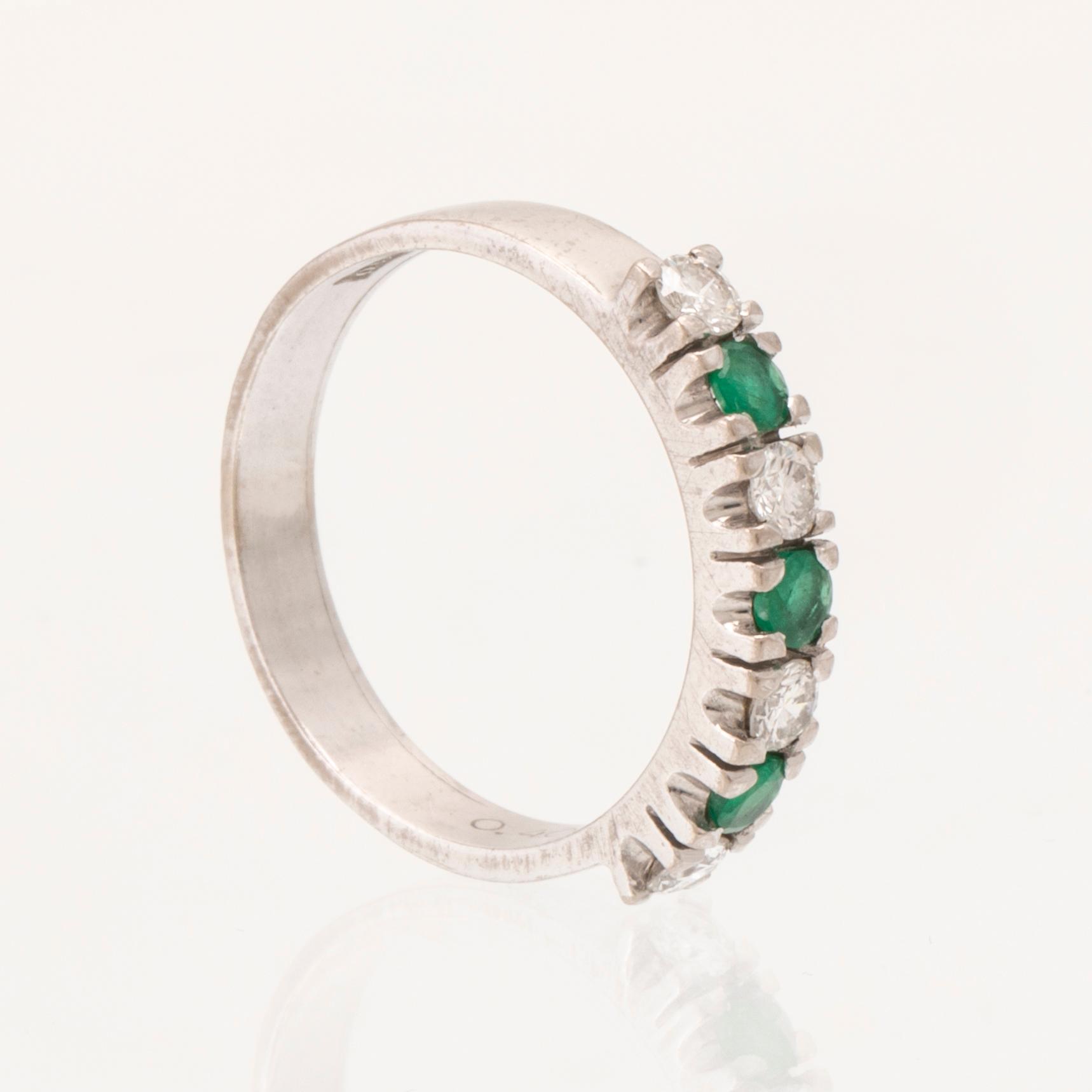Ring half-eternity 18K white gold with round faceted emeralds and diamonds, Heribert Engelbert Stockholm 1981.
