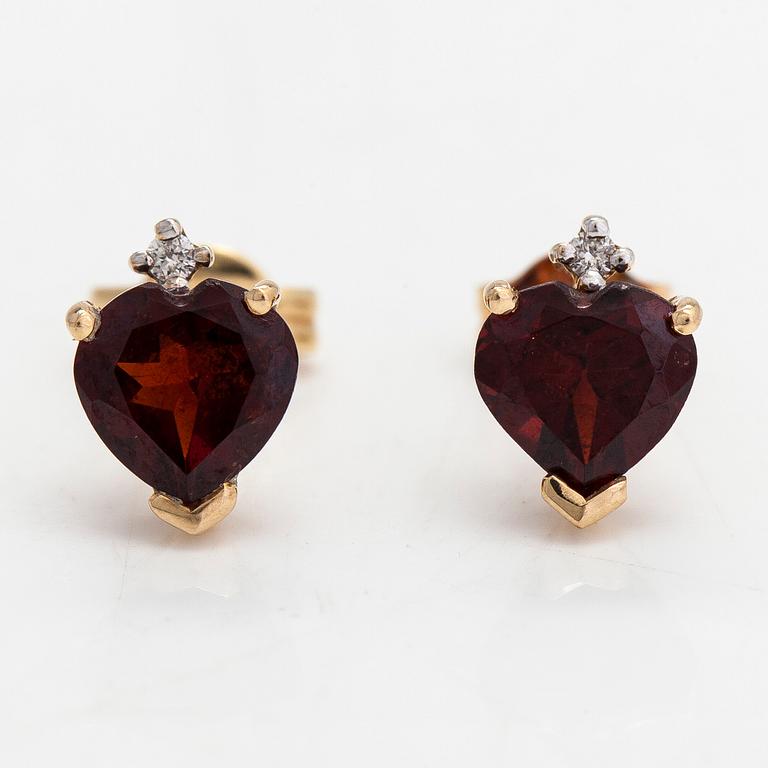 A pair of 14K gold earrings with garnets and diamonds ca 0.002ct in total.