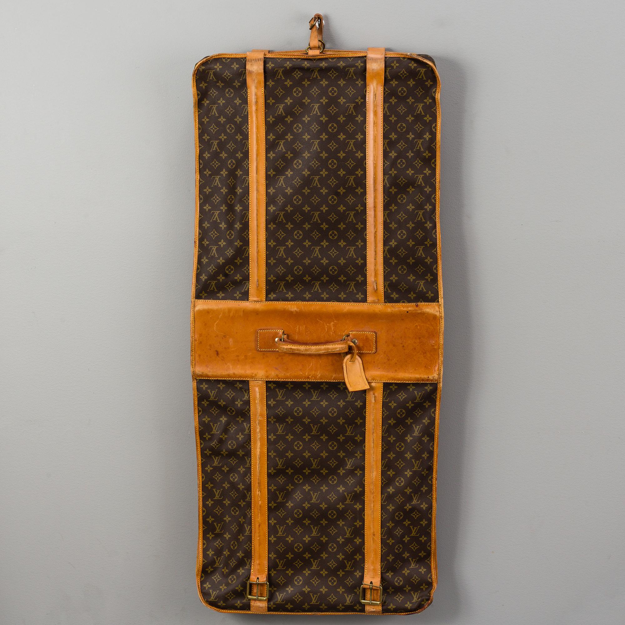 A Louis Vuitton vintage Monogram Canvas Homme Garment Bag.