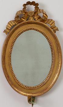 A pair of late Gustavian one-branch giltwood girandole mirrors, Stockholm, circa 1800.