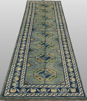 An Oriental runner, c. 296 x 77 cm.