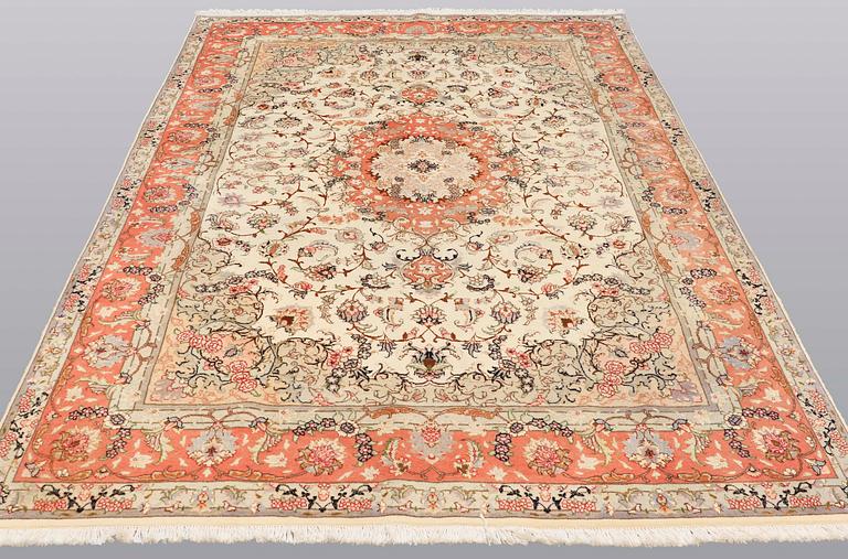 A carpet, Tabriz part silk, ca 302 x 200 cm.